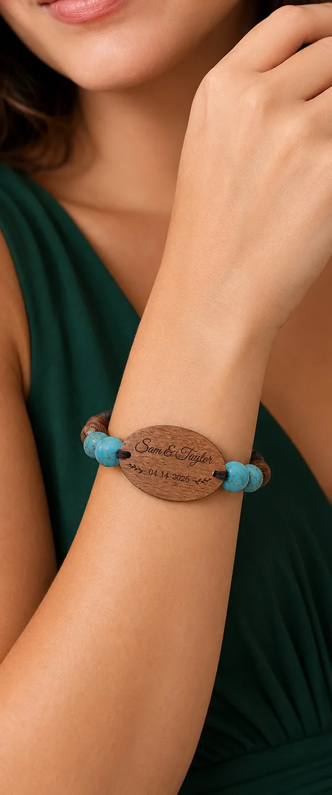 A wedding guest in a green dress wearing her engraved WearableWedding bead band on her wrist.